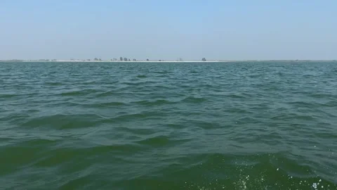 Sailing POV across the Padma river heading towards a small island in Char Stock Footage 346511180