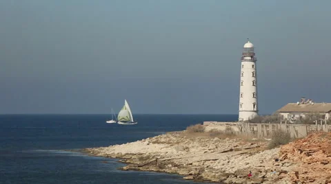 Sailing race on the background of the lighthouse Stock Footage 42763596
