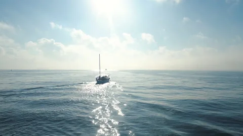 Sailing sail boat in the blue sea, aerial 4k sunrise video Stock Footage
