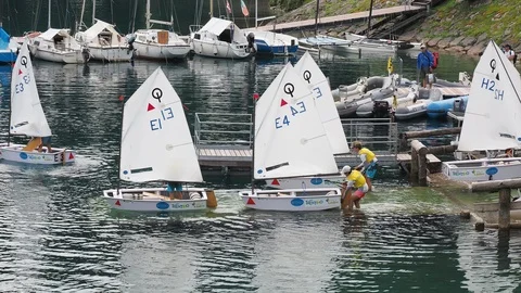 Sailing school on small boats. School on Lake Ledro. Alpine lake. Summer time Stock Footage 121605957