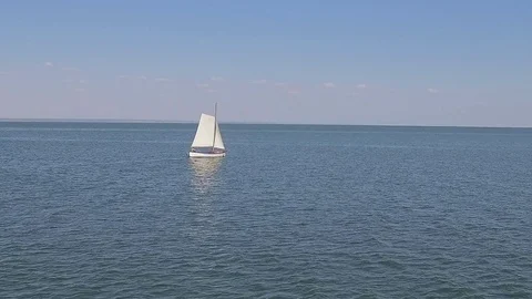 A sailing ship is in the calm waves of the ocean in calm weather Stock Footage 86429681