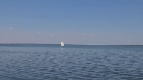 A sailing ship is in the calm waves of the ocean in calm weather Stock Footage 86429726