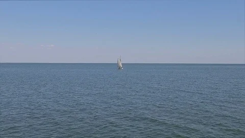 A sailing ship is in the calm waves of the ocean in calm weather Stock Footage 86429825