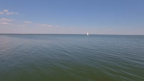 A sailing ship is in the calm waves of the ocean in calm weather Stock Footage 86446006