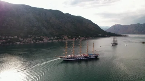 Sailing Ship Glides Gracefully Across a Beautiful Scenic Bay during Sunset Stock Footage 320745906