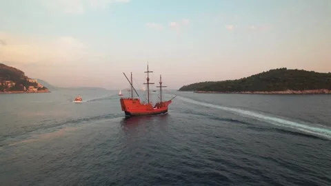 Sailing Ship Gracefully Navigating Calm, Serene Waters at the Sunset Hour Stock Footage 320749012