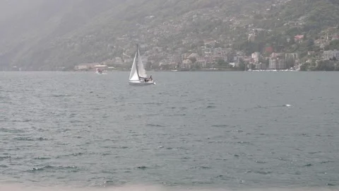 Sailing ship moves out of the frame left in Brissago, Ticino, Switzerland. 스톡 동영상 156777179