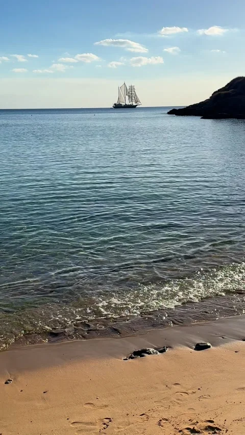 Sailing ship near the beach at sunset. Ios island, Greece Stock-Footage 300773100