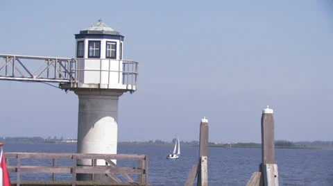 Sailing ship passes behind a lighthouse Stock Footage 25601416