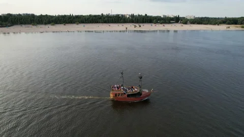Sailing ship sails on the calm waters along the river bank in sunny weather. Stock Footage 156839098