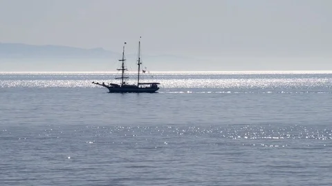 A sailing ship sails with motor and without wind on the calm sea Stock-Footage 89433378