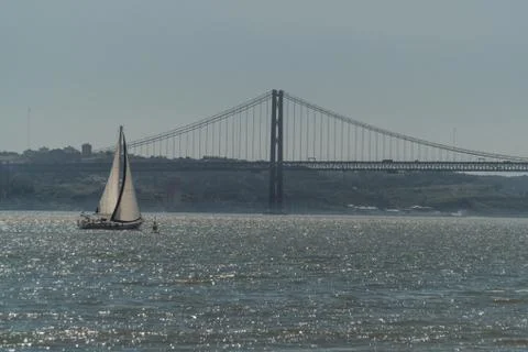 A sailing ship sails through the waters of the Tejo River on the coasts of th Stock Photos
