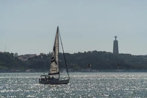 A sailing ship sails through the waters of the Tejo River on the coasts of th Photos