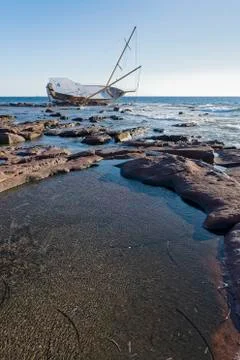 Sailing ship stranded on the rocks Stock Photos