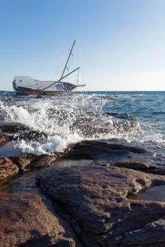 Sailing ship stranded on the rocks Stock Photos