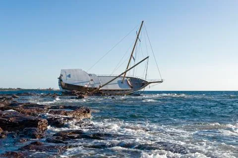 Sailing ship stranded on the rocks Stock Photos