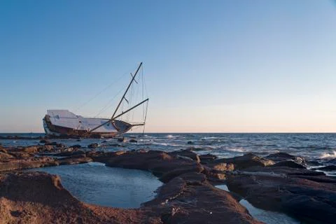 Sailing ship stranded on the rocks Stock Photos