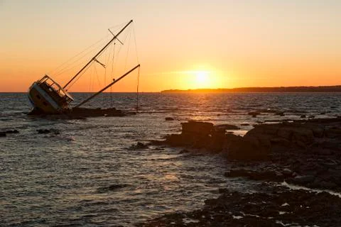 Sailing ship stranded on the rocks Stock Photos
