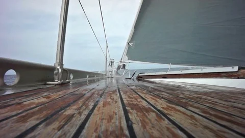 Sailing ship with wave splashing on the deck in slow motion Stockbeeldmateriaal 80989081
