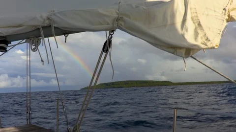 Sailing in the Solomons in view of rainbow and small island Stock Footage 108038943