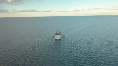 Sailing in to the sunset, aerail view of passenger cruise ship in the ocean. Stock Footage 139987332
