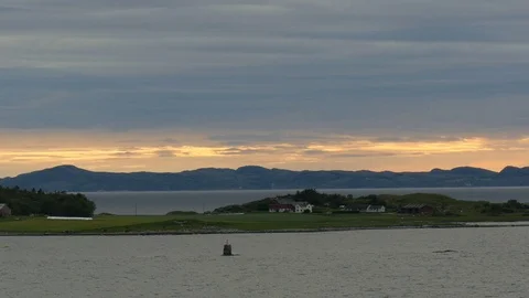 Sailing trough norwegian islets during midnight sun Stock Footage 78641153