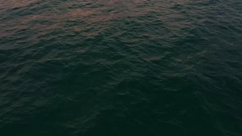 Sailing vessel glows in last light off lush island coast, Thailand Stock Footage 310270804