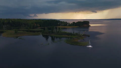 Sailing vessel hides in the calm lagoon on the lake before the incoming storm. Stock Footage 346636219