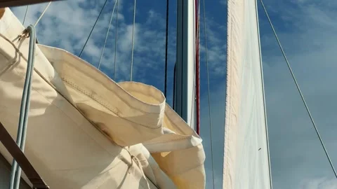 Sailing on the wind in a sailboat, view on with mast and sail. White sails open Stock Footage 320954712