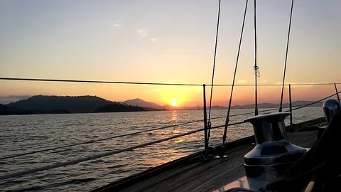 Sailing in the wind through the waves during sunrise Stock Footage