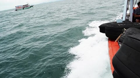 Sailing in the wind through the waves on sunny day in summer with water splas Stock Footage 64127697