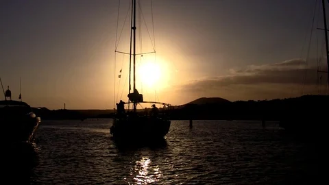 Sailing yacht against the backdrop of the setting sun Stock Footage 88911923