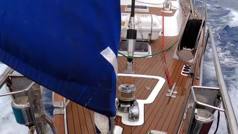 Sailing a yacht with blue sails through a tempest in the Drake Strait Stock Footage 289390334