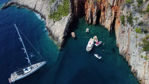 Sailing yacht exploring red rocks beach on hvar island, croatia Stock Footage 339777876