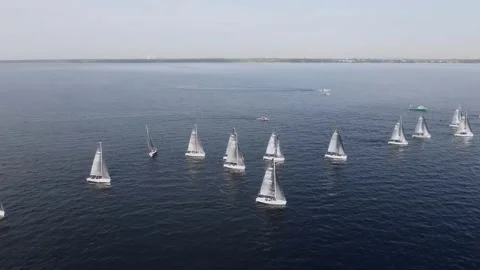 Sailing yachts lined up in the sea during a sailing regatta and cast shadows Stock Footage 197700178