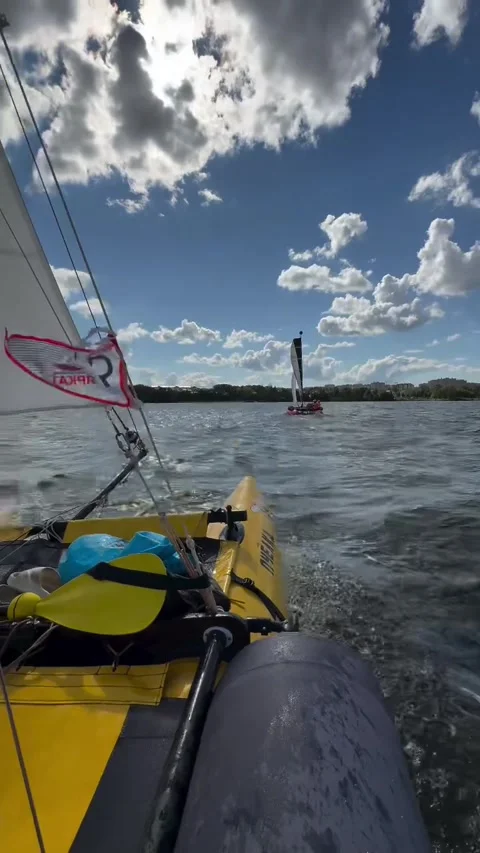 Sailing a Yellow Catamaran Boat on Open Water Under Cloudy Sky Video stock 341840876