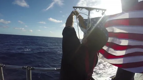 Sailor attaching the U.S.A flag on the Virginia-Class submarine USS Texas - 2017 Stock Footage 85032036