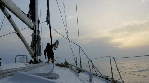 Sailor in the bow of the sailboat while sailing Video stock 55057532