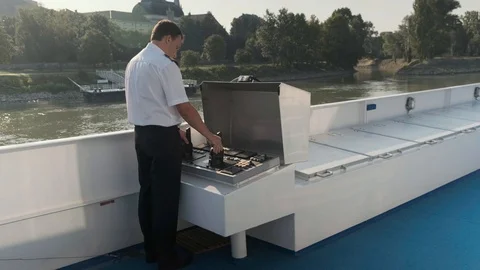 Sailor at the controls on the deck of a river boat Stock Footage 116183095