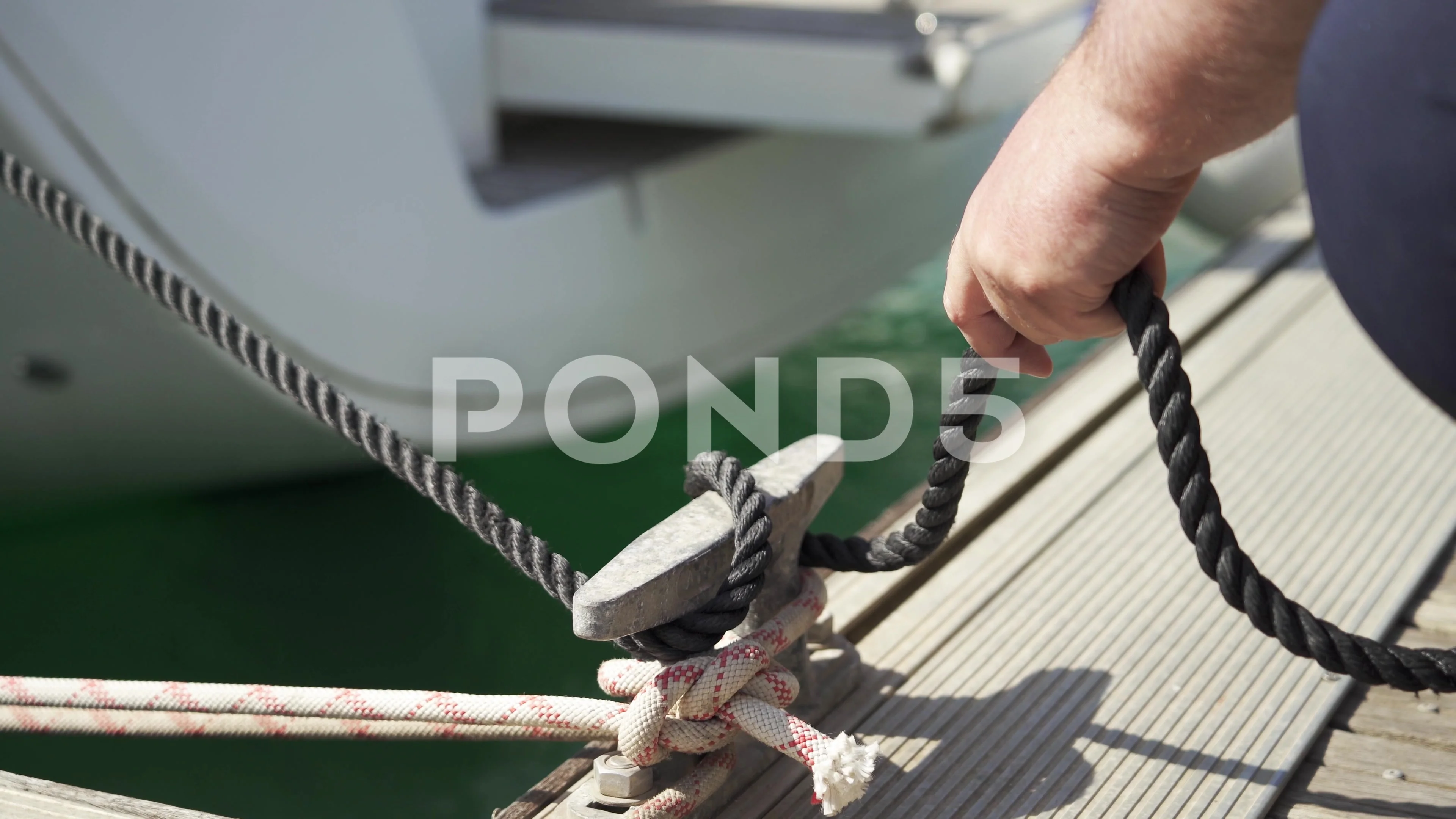 Sailing rope around a bollard - SuperStock