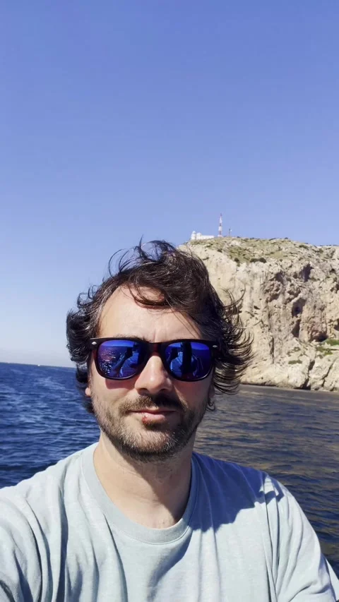 Sailor with dramatic coastal cliff in background Stock Footage 336569488