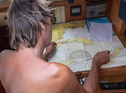Sailor in front of compass chart chart table on compass Stock Photos