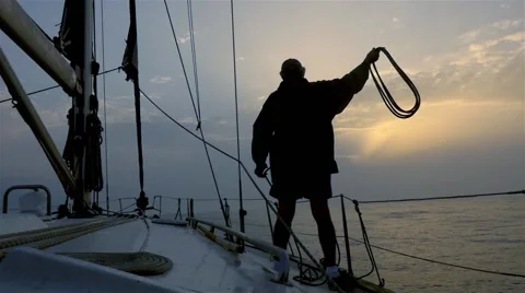 Sailor handles ropes in a sailboat while sailing Vídeo Stock 55057658