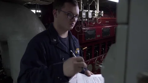 Sailor inspects and notes down observations in the engine room - 2017 Stock Footage 85030403
