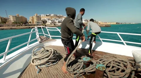 Sailor man pulling anchor boat in the sea Stock Footage 48571505