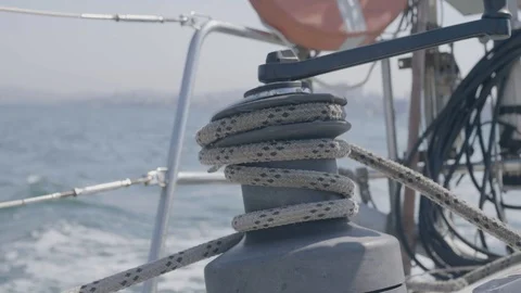 Sailor man using sail winch and rope while sailing on yacht in sea close up Stock Footage 92600895