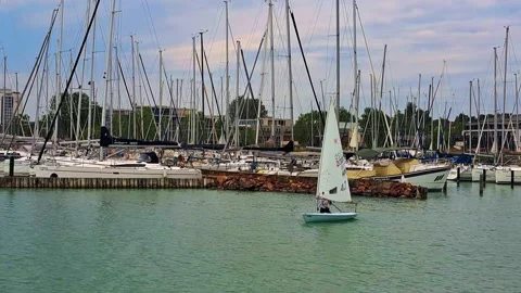 Sailor maneuvers a training sailboat 스톡 동영상 311574658