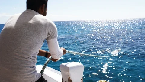 Sailor pulls the rope for diving on a yacht Stock Footage 105684763