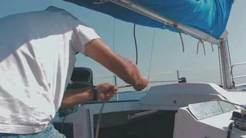 The sailor pulls the rope. the process of raising and lowering the sail. the sai Stock Footage 205925076
