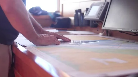 Sailor reading nautical chart map ship boat Stockbeeldmateriaal 83259943